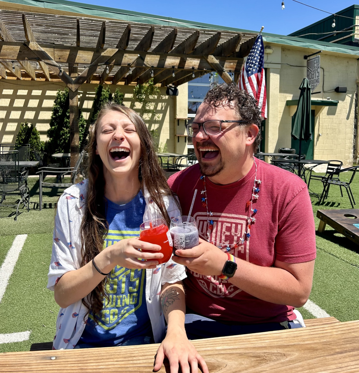 Wiley Roots employees wearing company merch and laughing with frozen drinks
